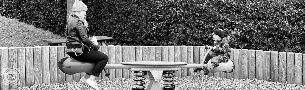 Mum and child sitting on seesaw