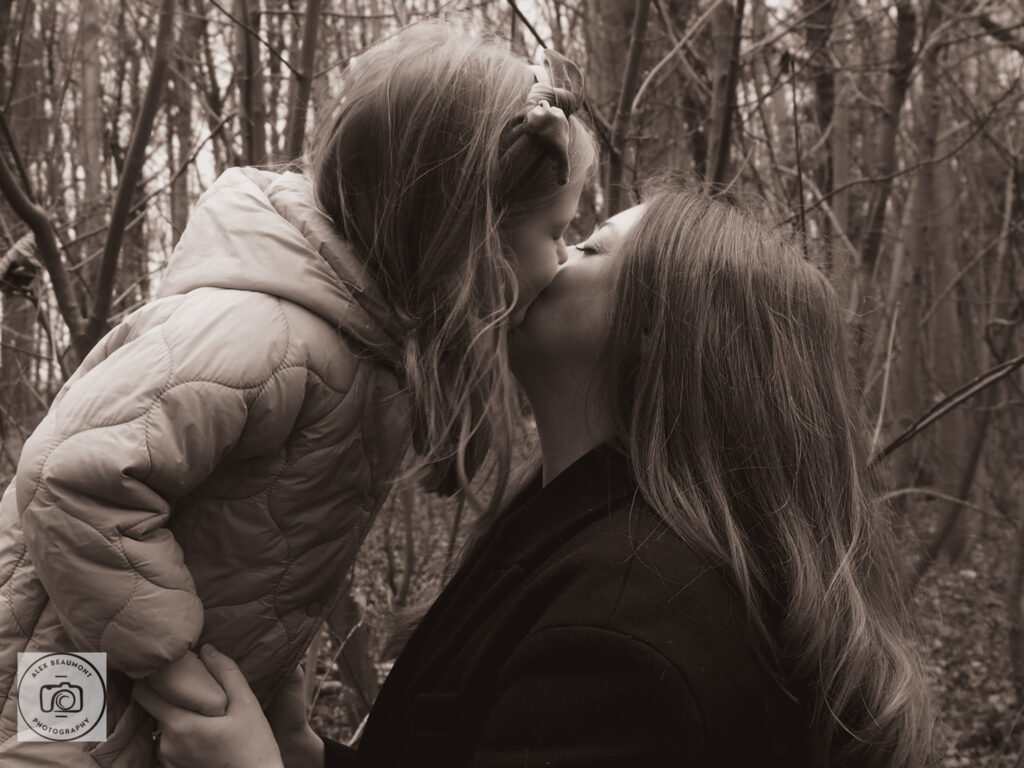 Daughter kissing mum