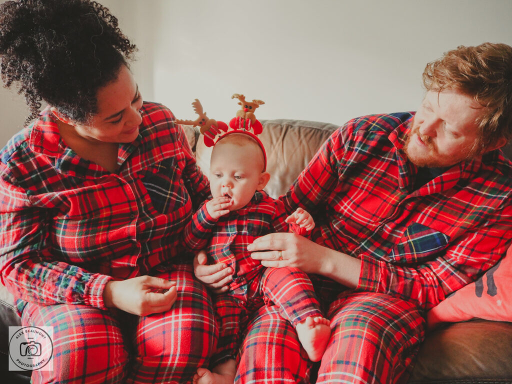 Mum, Dad and Baby wearing Christmas tartan pyjamas