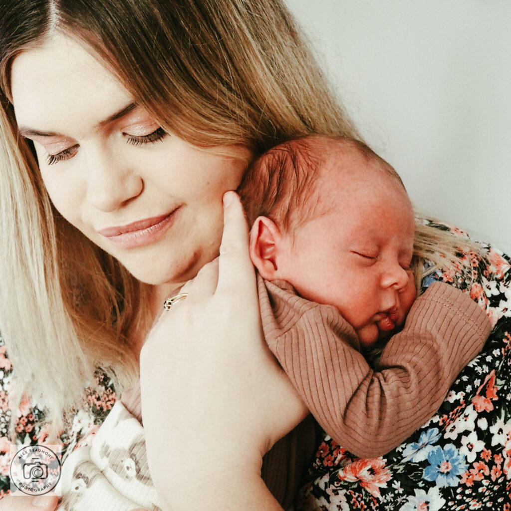 newborn photoshoot Sussex, Mum holding newborn